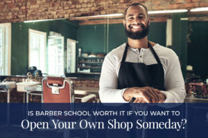 Barber shop owner smiling inside his shop